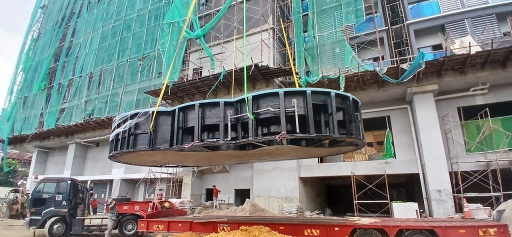 Hydro One® composite swimming pool suspended near building façade during Level 4 tower-crane installation.