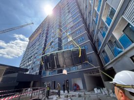 An 8m × 4m Hydro One® prefabricated pool being lifted towards its Level 4 installation location by tower crane at D'IMMERSIONE Mont Kiara.